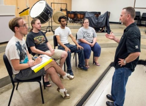 Dr. Scott Woodard meets with student volunteers at WVSU to discuss plans for the "Orchestra of the Hills" benefit performance.