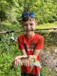 Owen Wian, age 10 of Martinsburg, W.Va. with one of the tiger trout he managed to catch while fishing with his dad at Summit Lake. 