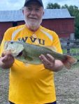 Rick Harshbarger of Keyser, W.Va. shows off a 5 pound bass he caught while fishing top water in a Mineral County farm pond