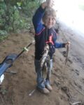Jaxson Blevins, age 7, during his first overnight fishing trip on the Ohio River.   He caught three fish that night and shows us his stringer. 
